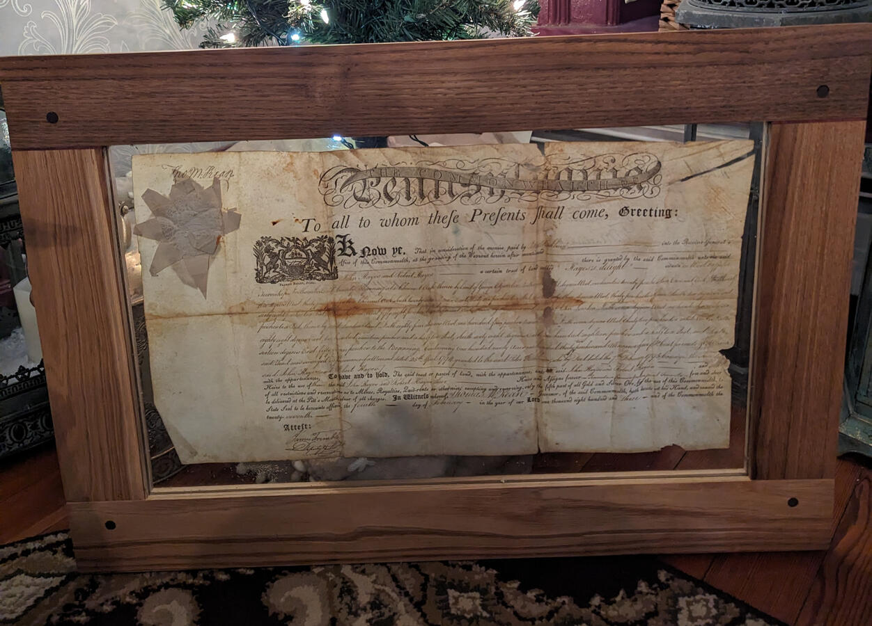 Antique document in custom frame. Antique document in custom frame.